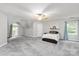 Spacious bedroom featuring cozy carpeting, natural light, and a modern ceiling fan at 8227 Lansford Rd, Charlotte, NC 28277