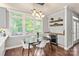 Dining area with large windows, stylish lighting, and a convenient wine fridge for entertaining at 8227 Lansford Rd, Charlotte, NC 28277