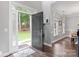 Light-filled foyer with hardwood floors, a welcoming entrance to the home at 8227 Lansford Rd, Charlotte, NC 28277
