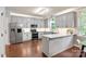 Bright kitchen with gray cabinets, stainless steel appliances, and a center island offering food prep space at 8227 Lansford Rd, Charlotte, NC 28277