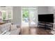 Bright living room featuring an open door leading to an outdoor seating area at 8227 Lansford Rd, Charlotte, NC 28277