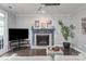 Cozy living room featuring a decorative fireplace, modern decor, and comfortable seating for relaxation at 8227 Lansford Rd, Charlotte, NC 28277