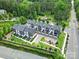 Aerial view showcasing modern townhomes with lush landscaping, mature trees, and convenient parking at 8723 Nolley Ct, Charlotte, NC 28270