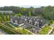 Wide aerial perspective of modern townhouses with parking, landscaping, and green surroundings at 8723 Nolley Ct, Charlotte, NC 28270