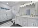 Elegant bathroom featuring double vanity, quartz countertop, sleek fixtures and a glass enclosed shower at 8723 Nolley Ct, Charlotte, NC 28270