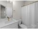 Cozy bathroom featuring a vanity with gold fixtures, toilet and shower with curtain at 8723 Nolley Ct, Charlotte, NC 28270