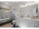 Modern bathroom featuring a glass-enclosed shower and dual-sink vanity with gold fixtures at 8723 Nolley Ct, Charlotte, NC 28270