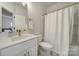 Clean bathroom featuring single vanity, sleek fixtures and a shower with a curtain at 8723 Nolley Ct, Charlotte, NC 28270