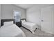 Shared bedroom featuring two twin beds, soft carpet and a window at 8723 Nolley Ct, Charlotte, NC 28270