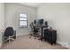 Bedroom featuring a desk setup with a modern monitor and neutral-toned carpet at 8723 Nolley Ct, Charlotte, NC 28270