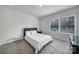 Cozy bedroom with neutral tones, a comfortable bed, and natural light at 8723 Nolley Ct, Charlotte, NC 28270