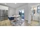Dining area featuring a round table, modern chairs, and sliding glass doors leading to a balcony at 8723 Nolley Ct, Charlotte, NC 28270