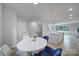 Bright dining area with a white table, blue chairs, and an open-concept view to the kitchen island at 8723 Nolley Ct, Charlotte, NC 28270