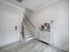 Inviting entryway with light gray walls, modern shoe cabinet, and stairs leading to the upper level at 8723 Nolley Ct, Charlotte, NC 28270