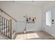 Bright entryway with staircase and modern accent cabinet creates a welcoming atmosphere at 8723 Nolley Ct, Charlotte, NC 28270