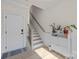 Inviting entryway features a modern staircase, and stylish decor with sleek white accent furniture at 8723 Nolley Ct, Charlotte, NC 28270
