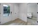 Bright entryway featuring wood-look flooring, a modern door, and access to a bedroom at 8723 Nolley Ct, Charlotte, NC 28270