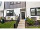 A close-up exterior showcases black framed entry door, landscaping, and modern design elements at 8723 Nolley Ct, Charlotte, NC 28270