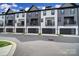 Modern townhome showcases black garage doors, minimalist balconies, and striking black and white facade at 8723 Nolley Ct, Charlotte, NC 28270
