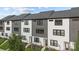 Modern townhome exterior featuring white and gray siding, black trim, and well-maintained landscaping at 8723 Nolley Ct, Charlotte, NC 28270