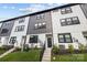 Modern townhome showcases black and white siding, black trim windows, and well-manicured lawn at 8723 Nolley Ct, Charlotte, NC 28270