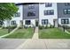 Modern townhome exterior with a landscaped yard and sleek architecture at 8723 Nolley Ct, Charlotte, NC 28270