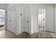 Hallway featuring wood floors, white trim, and doors leading to various rooms at 8723 Nolley Ct, Charlotte, NC 28270