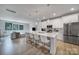 Bright and modern kitchen with a large island, white cabinets, and stainless steel appliances at 8723 Nolley Ct, Charlotte, NC 28270