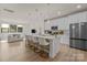 Open concept kitchen features a large island, stainless steel appliances, and modern lighting fixtures at 8723 Nolley Ct, Charlotte, NC 28270