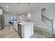 Spacious kitchen island featuring stainless steel appliances, white cabinetry, and a modern design at 8723 Nolley Ct, Charlotte, NC 28270