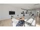 Open concept living room and kitchen with modern white cabinetry and a comfortable grey sofa at 8723 Nolley Ct, Charlotte, NC 28270