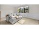 Bright living room with a comfortable grey sofa, large windows, and modern decor at 8723 Nolley Ct, Charlotte, NC 28270
