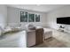 Bright living room with large windows, a comfortable sofa, and modern decor at 8723 Nolley Ct, Charlotte, NC 28270