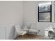 Cozy sitting area with wainscoting, bright windows, and modern decor at 8723 Nolley Ct, Charlotte, NC 28270