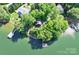 Stunning aerial view of lakeside home surrounded by lush greenery and private dock at 9289 Azalea Rd, Sherrills Ford, NC 28673