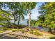 Scenic backyard featuring lush greenery and steps down to the lake with a small dock at 9289 Azalea Rd, Sherrills Ford, NC 28673