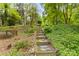 Picturesque backyard with stone steps, rock gardens, and natural landscaping leading to the lake at 9289 Azalea Rd, Sherrills Ford, NC 28673
