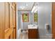 Bright bathroom featuring a single vanity, tiled floors, and a window with natural light at 9289 Azalea Rd, Sherrills Ford, NC 28673