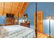 Bright bedroom featuring a four-poster bed, wood floors, and blue walls at 9289 Azalea Rd, Sherrills Ford, NC 28673