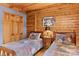 Charming bedroom featuring two twin beds, wood-paneled walls, and a cozy atmosphere at 9289 Azalea Rd, Sherrills Ford, NC 28673