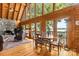 Cozy dining area with lake views, stone fireplace, and wood accents, creating a warm and inviting space at 9289 Azalea Rd, Sherrills Ford, NC 28673