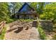 Charming home exterior featuring stone accents, a balcony, and inviting outdoor spaces at 9289 Azalea Rd, Sherrills Ford, NC 28673