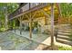 Outdoor area under a raised deck with stone columns and staircase to the backyard at 9289 Azalea Rd, Sherrills Ford, NC 28673