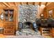 Rustic stone fireplace with wood accents and a stone hearth, adding warmth and character to the living space at 9289 Azalea Rd, Sherrills Ford, NC 28673