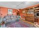 Comfortable living room with leather sofa, hardwood floors, and built-in bookshelves at 9289 Azalea Rd, Sherrills Ford, NC 28673