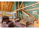 Open living room with high ceilings, a staircase, and comfortable leather furniture at 9289 Azalea Rd, Sherrills Ford, NC 28673