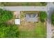 An aerial view of a cozy home with a detached garage, nestled on a spacious lot surrounded by lush greenery at 1000 Oakshade Ave, Kannapolis, NC 28083