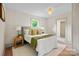 Bright bedroom with a comfortable bed, white linens, and a view into the bathroom at 1000 Oakshade Ave, Kannapolis, NC 28083