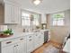 Updated kitchen with white cabinetry, sleek countertops, and modern stainless steel appliances at 1000 Oakshade Ave, Kannapolis, NC 28083