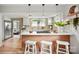 Open kitchen with stainless steel appliances, white countertops, and a functional island with barstool seating at 1000 Oakshade Ave, Kannapolis, NC 28083